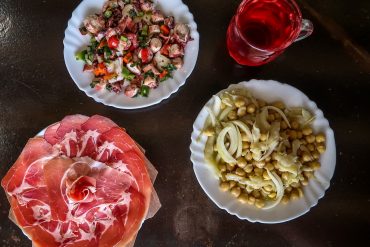 Plates of meat, cod and chickpea salad, and octopus salad