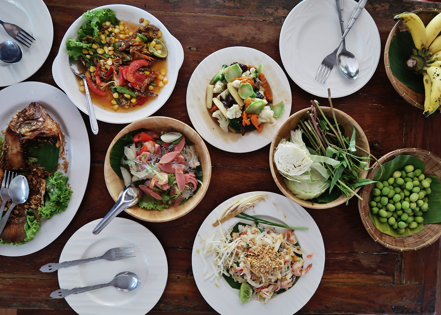 Birds eye view of a table of small dishes of thai food