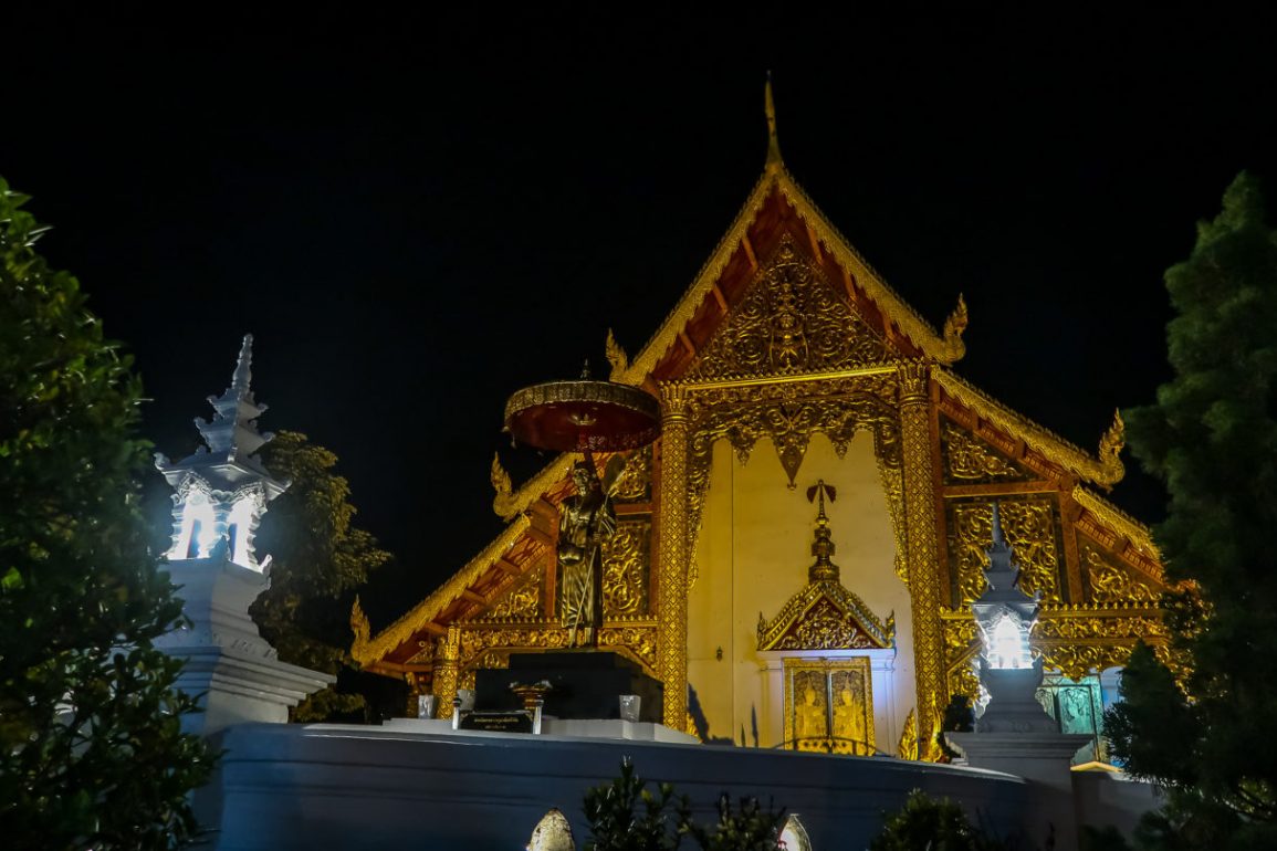 Temple in gold lit up at night time