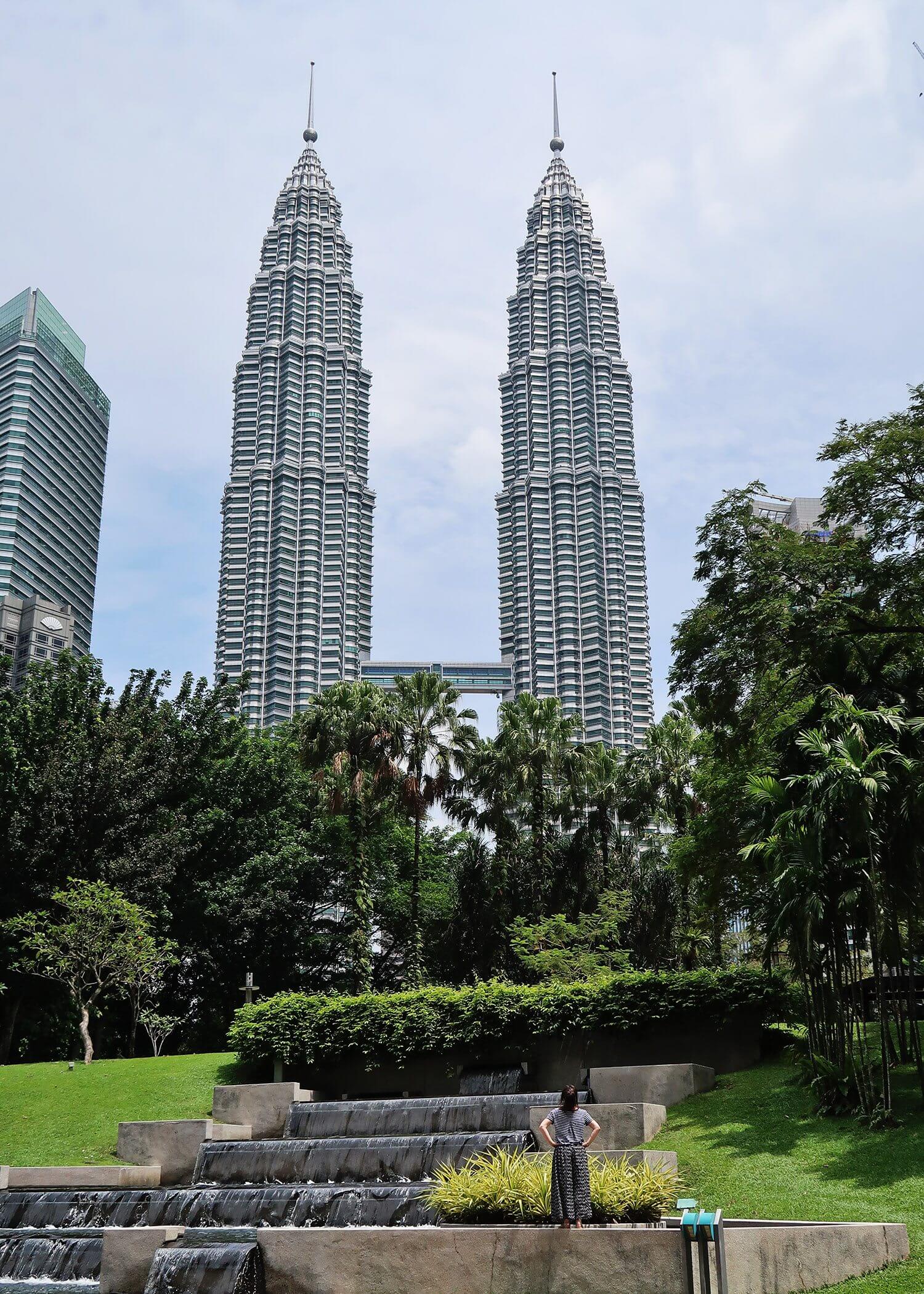 Petronas towers are 2 large skyscrapers with a bridge connecting them